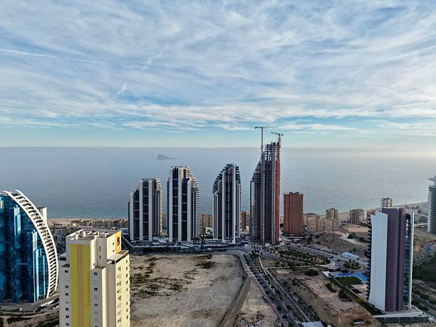 istock elegant seaside buildings under development, luxury towers along peaceful shoreline being built 2251502015