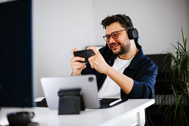 istock Young men playing video games with desktop 2251503537