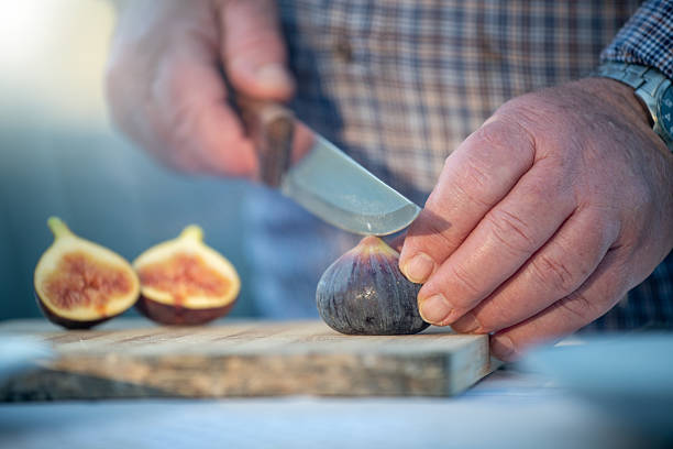 Chef cutting fresh figs to make a delicious homemade fig dessert.