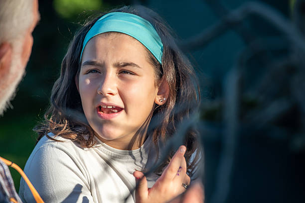 Cute little boy with static electricy hair, having his funny portrait taken outdoors on a trampoline