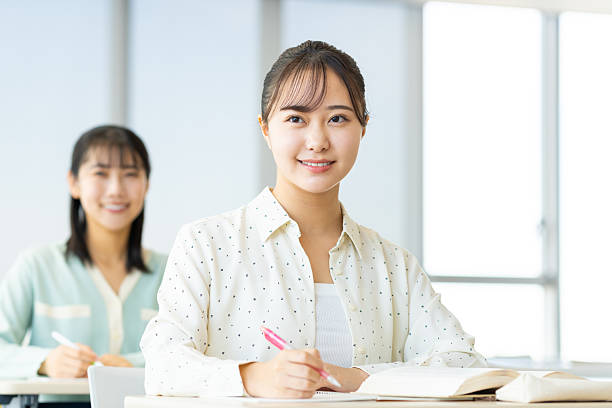 Female college student attending a lecture at university