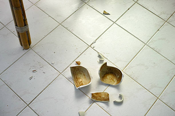 used teacup broken onto pieces and abandoned on the room floor