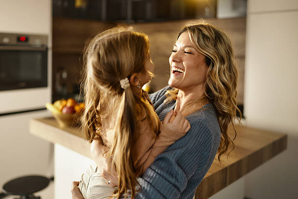 istock Cheerful mother having fun with her daughter at home. 2251510995