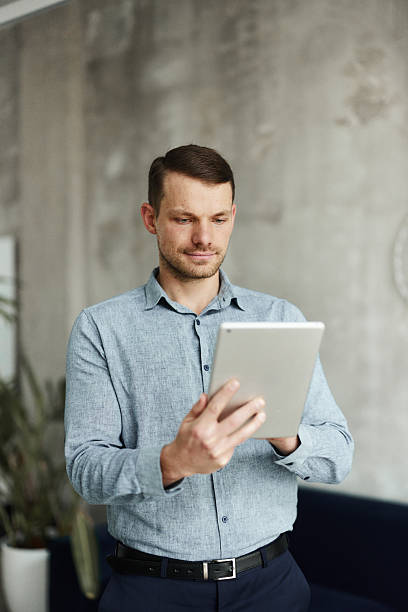istock Young male entrepreneur working on touchpad in the office. 2251512286
