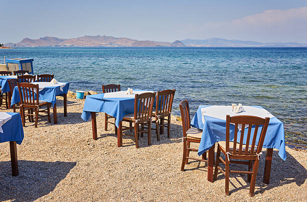 istock Greek beach with traditional blue tables and chairs 2251512665