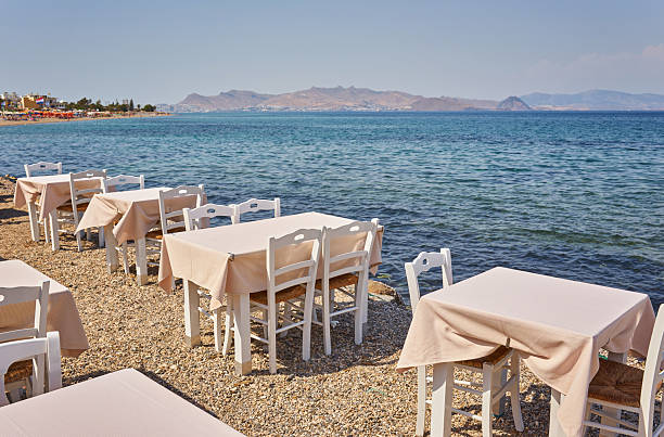 istock Greek beach with traditional blue tables and chairs 2251512669