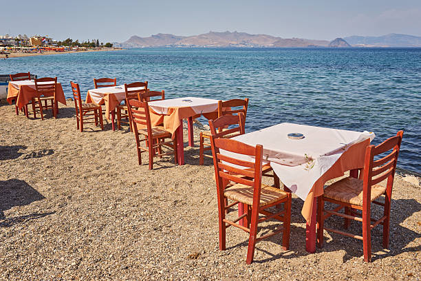 istock Greek beach with traditional blue tables and chairs 2251512679