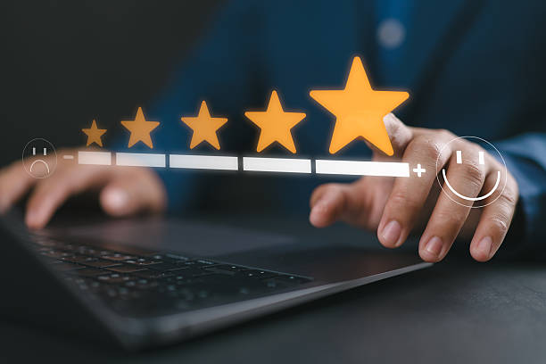 istock User feedback and five-star rating system. Businessman using laptop and selecting maximum star level with smiley icon, representing excellent digital experience and customer satisfaction. 2251513127