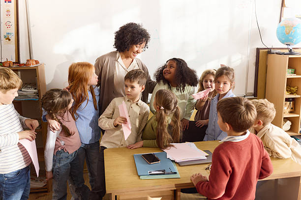 istock Happy teacher talking to her students during creative class at elementary school. 2251513768