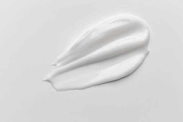 istock Liquid cream cosmetic smudge drops texture on white background. cosmetic smears cream texture 2251513792