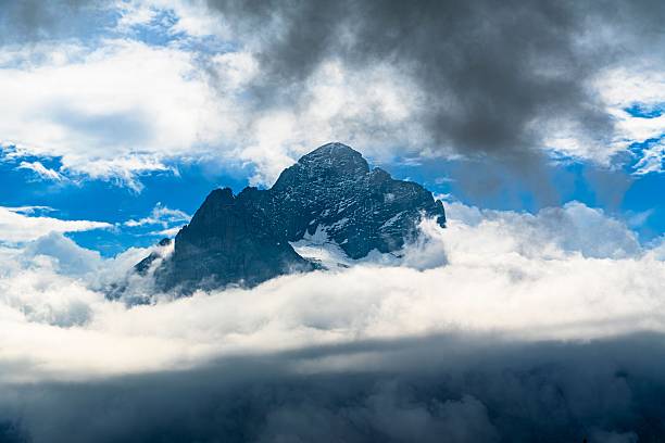 istock Dramatic alpine peak rising majestically above a thick layer of swirling clouds 2251513852