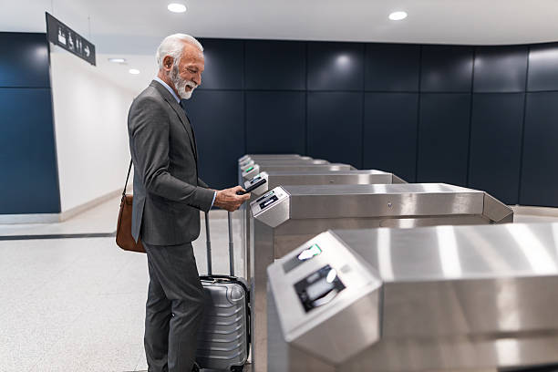 istock Businessman Scans Ticket at Turnstile in Modern Train Station 2251514267