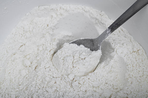 istock White flour in a bowl being mixed with a tablespoon, close-up 2251514459