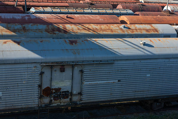 istock Rusted freight train cars standing in sunlight, featuring textured metal surfaces and industrial details, ideal for transportation and urban decay themes. 2251515471