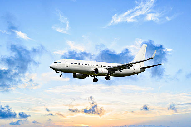 istock Passenger plane landing at the airport, under a blue sky with white clouds 2251515942