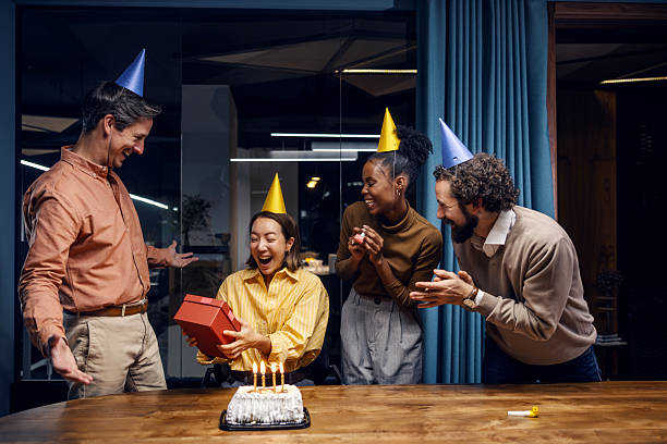 istock Colleagues celebrating surprising birthday party in office 2251517409