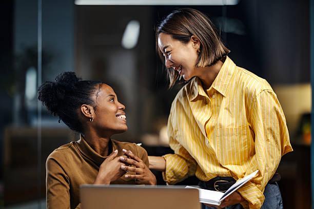 istock Diverse businesswomen collaborating and smiling in office 2251517485