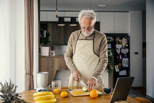 istock Senior man preparing healthy fruit smoothie in kitchen 2251518736