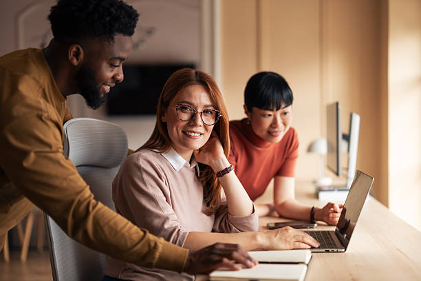 istock Young Professionals Collaborating and Using a Laptop at a Modern Office Workspace 2251522917