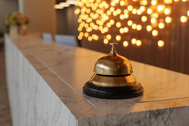 istock Hotel Reception Desk Bell on Marble Counter with Warm Ambient Lighting 2251523790