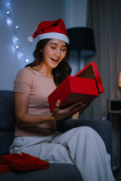 istock Young woman opening Christmas gift box creating surprise 2251526049