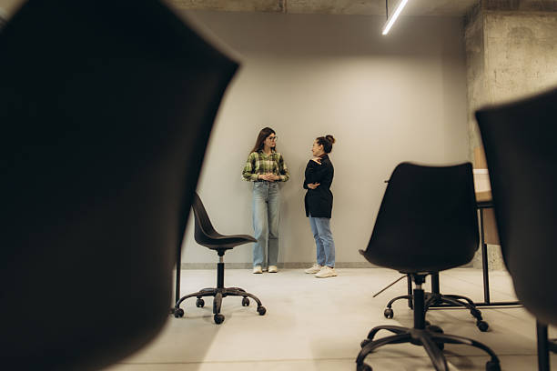 istock Colleagues Discussing in a Modern Office Environment with Minimalist Design 2251533127
