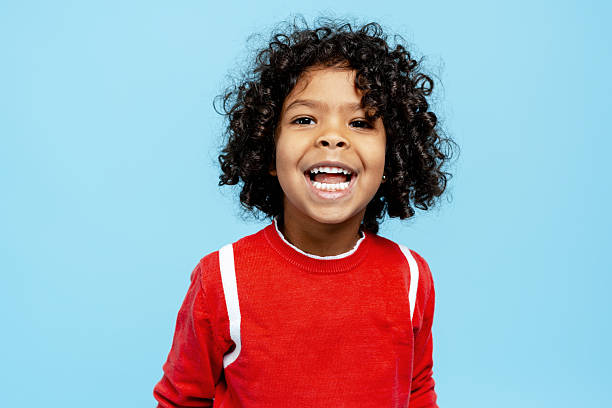 istock Happy child laughing, showing joy and excitement on a blue background 2251535517