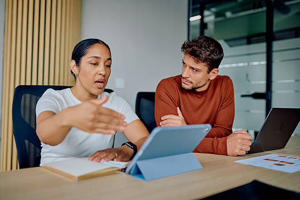 istock Colleagues collaborating on business project during office meeting 2251536147