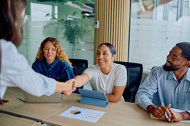 istock Diverse business team greeting new colleague with handshake 2251536451