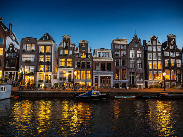 Amsterdam illuminated bridges at the Herengracht during a winter evening in the downtown canal district. The Netherlands.