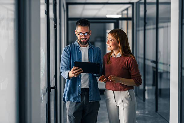istock Colleagues Collaborating and Discussing Ideas in a Modern Office Corridor 2251536689