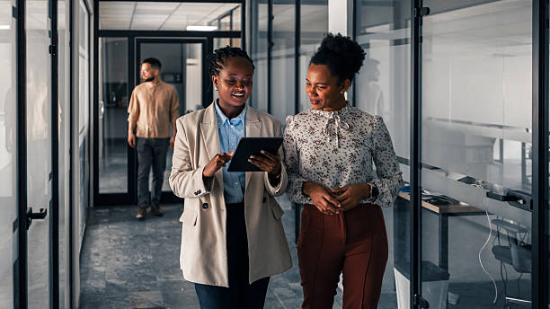 istock Professional Colleagues Discussing Business Strategy While Walking Together in Modern Office 2251536809