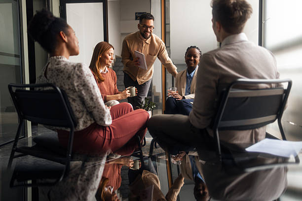 istock Casual Business Discussion Among Team Members in Modern Office Setting 2251537111