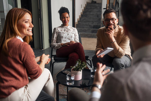 istock Group Discussion in Modern Office with Smiling Team Members 2251537115