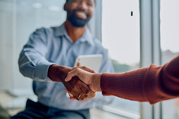 istock Smiling african American businessman shaking hands with client 2251539190
