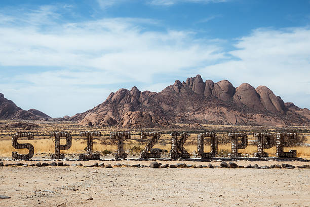 spitzkoppe letters  in front of mountain range in the namib dessert