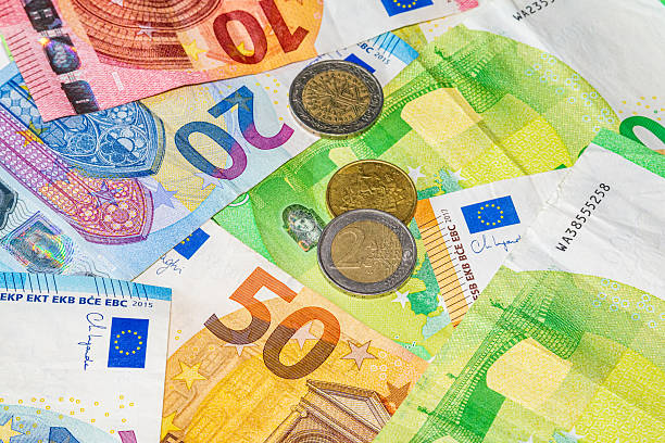 istock Assorted euro banknotes and coins arranged together, showing colorful currency design, security details and mixed denominations 2251541382