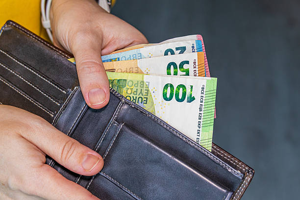 istock Hands pulling euro banknotes from a leather wallet, symbolizing personal finance, cash handling, budgeting, savings 2251541437