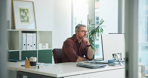 istock Review, man or think with computer in office, internal control ideas or risk management observation. Reading, check financial records or auditor with policy compliance insight, pc or asset reflection 2251544705