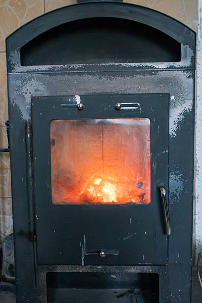 istock Wood-burning stove with glowing fire inside 2251544735