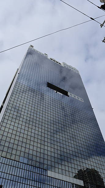 istock A tall glass building with a reflective facade that mirrors the sky 2251545302