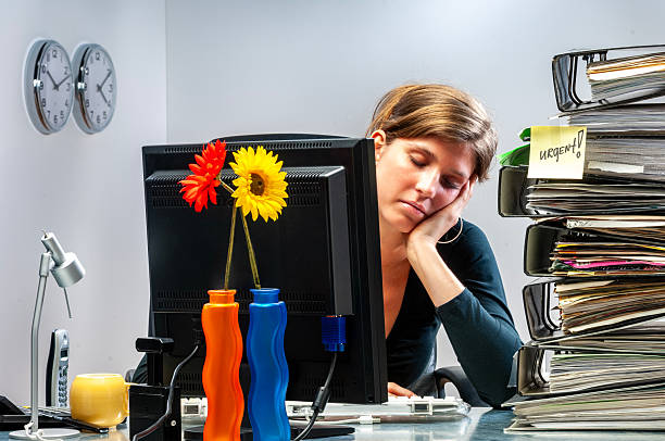 istock Young woman in office working late 2251547366