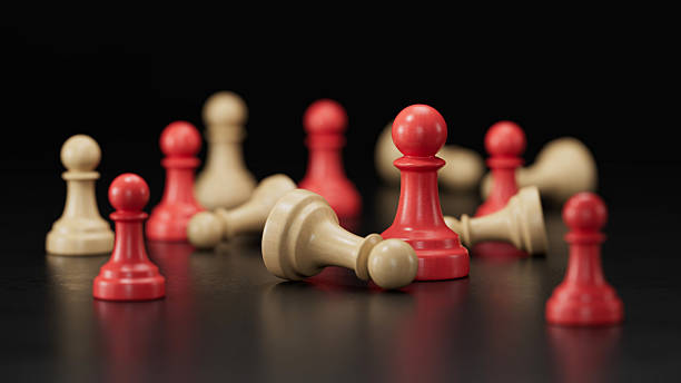istock Red Pawn Standing Amid Fallen Beige and Red Pieces: Symbolizing Resilience 2251548203