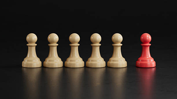 istock Solo Red Pawn Apart From Five Beige Pawns: Symbolizing Uniqueness 2251548211
