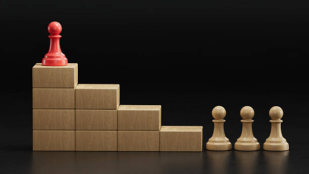 istock Red Pawn Tops Stepped Tower: Leadership Amid Ranked Progression 2251548249