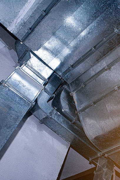 istock Industrial air ventilation ducts installed on a ceiling for HVAC system, showing airflow distribution and climate control. HVAC. Construction. Building infrastructure. 2251548572
