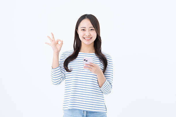 istock Young woman using a smartphone on a white background 2251548911