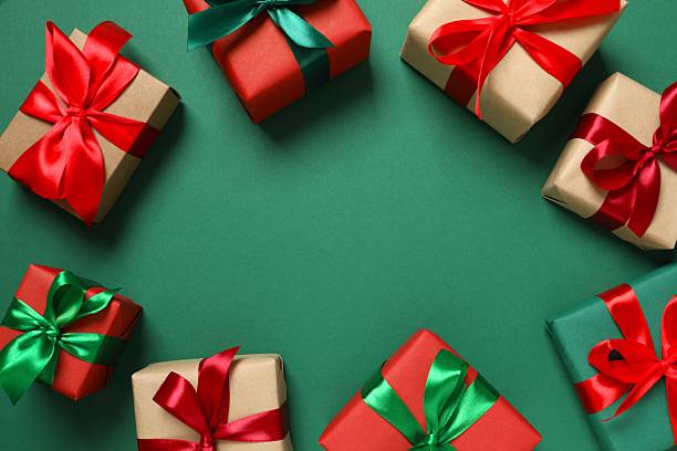 istock Top view of gift boxes tied with bows on green background 2251550152