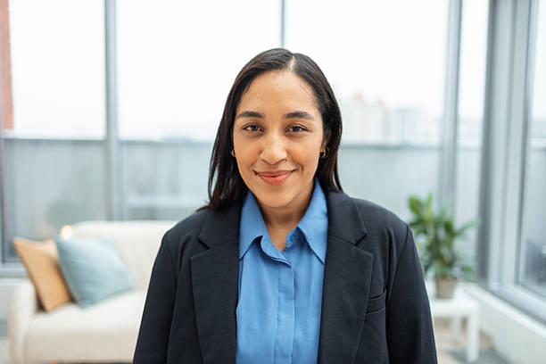 istock Confident businesswoman smiling in modern office environment 2251550794