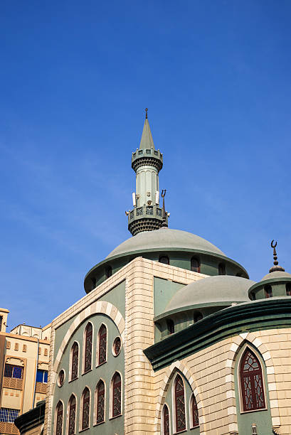 istock Low-Angle View of a Traditional Mosque with Minaret Against Blue Sky 2251551951